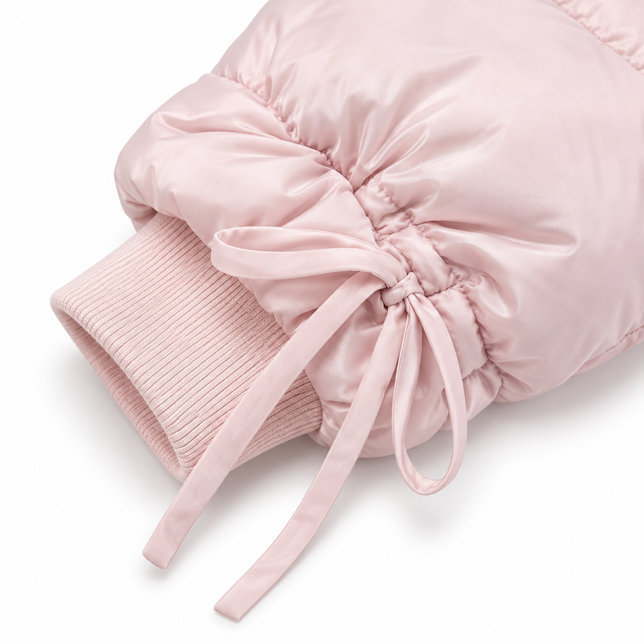 A close-up of a light pink puffer sleeve with a ribbed knit cuff and matching drawstring tie, shown on a clean white background.
