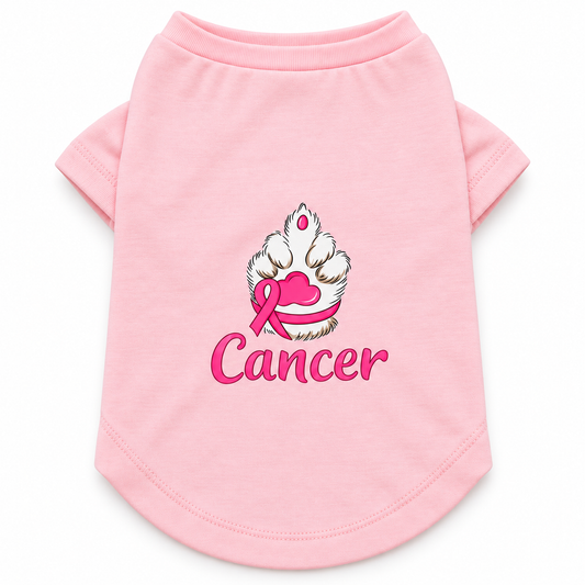 A pink short-sleeve pet shirt featuring a graphic of a paw print with a pink ribbon and the word 'Cancer' printed below it, displayed on a clean white background.