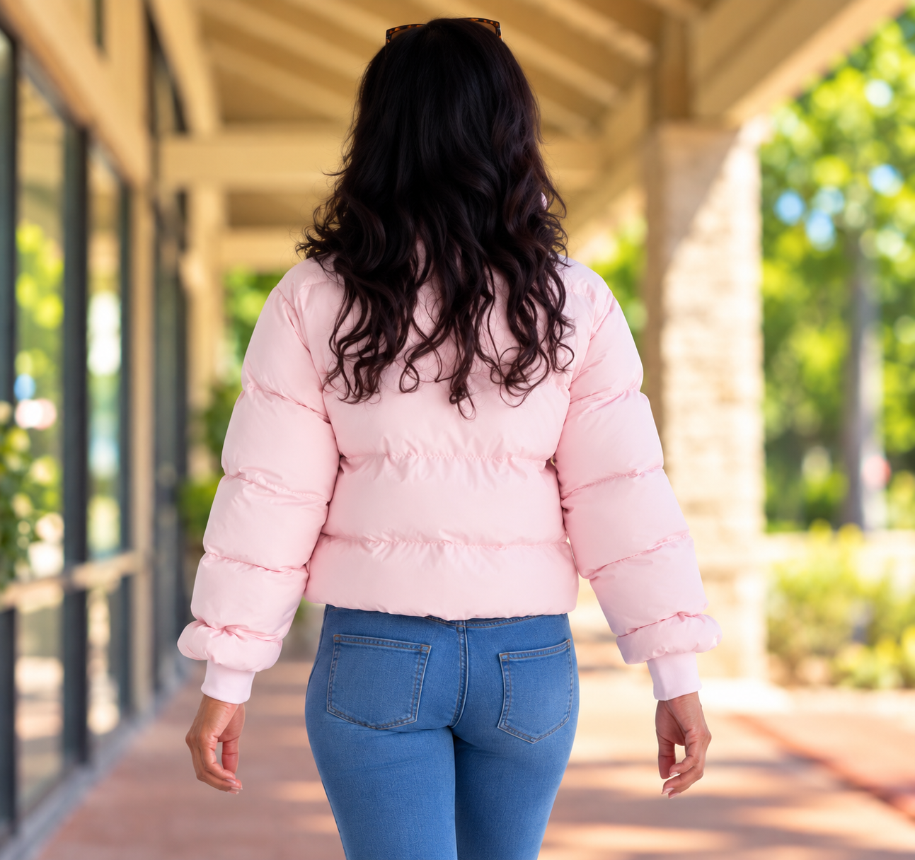 Women's pink puffer jacket. Embroidered paw logo with a pink bow around the wrist. The word cancer is under the paw. 