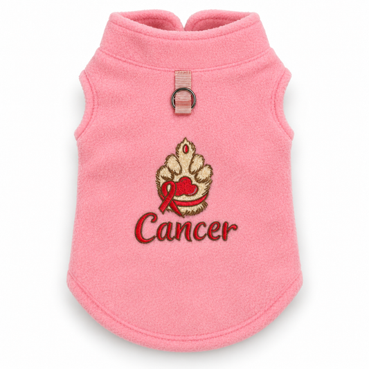 A soft pink fleece pet sweater with an embroidered design featuring a gold and red paw print with a red ribbon and the word 'Cancer' in red script.